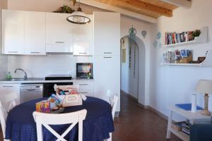 a kitchen with a table with a box on it at Salina Holiday Home in Calasetta