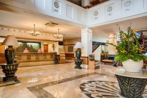 a lobby of a hotel with a reception desk at Hotel Sahid Jaya Lippo Cikarang in Cikarang