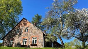 an old stone house in the middle of trees at Lauku sēta Svētupes in Salacgrīva +40 photos