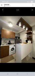 a kitchen with a white stove and a sink at Pinili Homestay in Suba