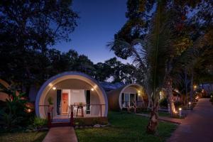 a small house with a round entrance at night at Tube Resort by EHM in Koh Rong Sanloem