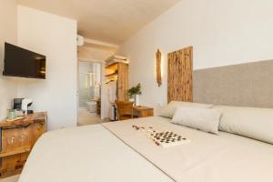 a bedroom with a chess board on a bed at Marinaio di foresta Bedroom in Baunei