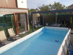 a swimming pool in the backyard of a house at Casa Surf Lanzada in Sanxenxo