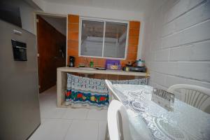 a kitchen with a counter and a table and a window at Casa corazón del pueblo in Calima +36 photos