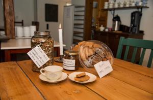 a table with a candle and a cup of tea and bread at Munkamöllan B&B Skåne Tranås in Skåne-Tranås +45 photos