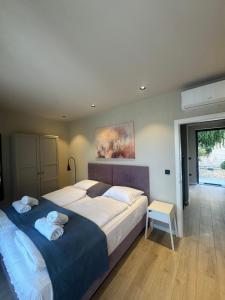 a bedroom with a large bed with towels on it at Vila Marila in Stara Novalja +95 photos