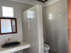 a bathroom with a sink and a toilet at Kutabay Homestay in Kuta Lombok +37 photos