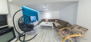 a living room with a couch and a tv at Villa UpTown in Mostar