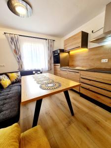 a living room with a table and a kitchen at Apartment Katzensilber in Rothenthurm +50 photos