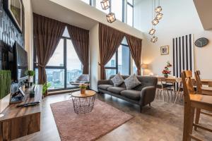 a living room with a couch and a table at KLCC Expressionz by WGS, 300Mbps WiFi in Kuala Lumpur