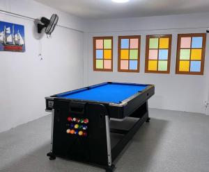 a pool table in a room with stained glass windows at Yoosabai Hostel And Guesthouse in Bangkok