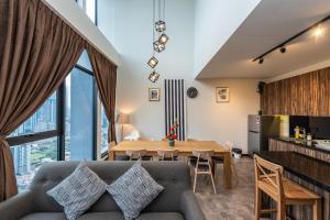 a living room with a couch and a table at KLCC Expressionz by WGS, 300Mbps WiFi in Kuala Lumpur