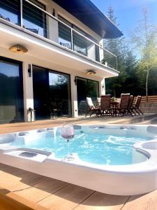 a hot tub in the backyard of a house at Opal Villa in Băile Tuşnad