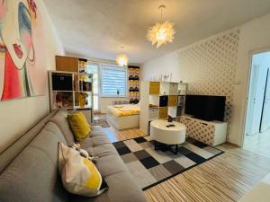 a living room with a couch and a tv at Apartment city centrum in Nitra