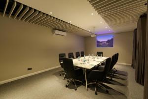 a conference room with a long table and black chairs at Aprota Villas in Arugam Bay +74 photos