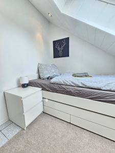 ein Schlafzimmer mit einem Bett mit weißen Kommoden in der Unterkunft FeWo Sundernblick in Haltern