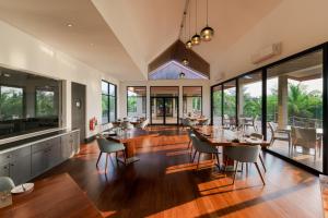 an open kitchen and dining room with tables and chairs at Aprota Villas in Arugam Bay