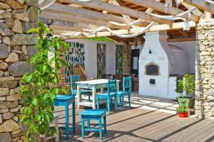 a patio with a table and chairs and a fireplace at Koczor Winery & Guesthouse in Balatonfüred
