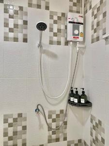 a shower with a shower head in a bathroom at De Chalet in Bangkok