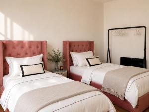 a bedroom with two beds and a mirror at ComeCasa Langhe Garden House-Pace e Panorama a Benevello in Benevello