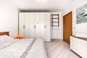 a bedroom with white cabinets and a bed at Eden Beach House - Host Solution in Cavallino-Treporti