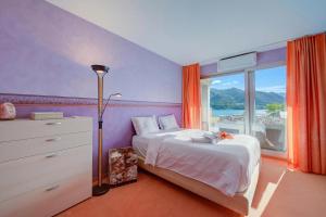 a bedroom with a bed and a dresser and a window at Panorama Maggiore Apartment with Pool in Locarno - Happy Rentals in Locarno