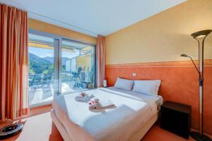 a bedroom with a large bed and a large window at Panorama Maggiore Apartment with Pool in Locarno - Happy Rentals in Locarno +22 photos