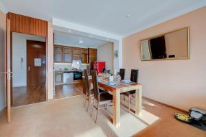 a kitchen and dining room with a table and chairs at Panorama Maggiore Apartment with Pool in Locarno - Happy Rentals in Locarno