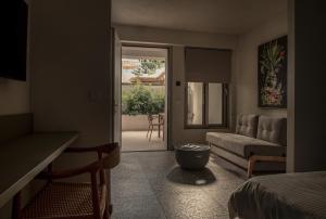 a living room with a bed and a couch at FOS Luxury Suites in Nikiti