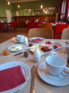 a table with plates and bowls of food on it at KulturHaus Locktow in Locktow +20 photos