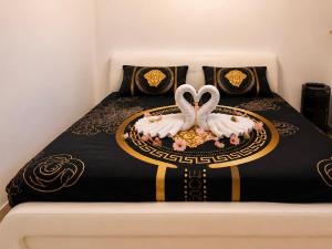 two swans are sitting on top of a bed at Olympus B&B in Mitzpe Ramon