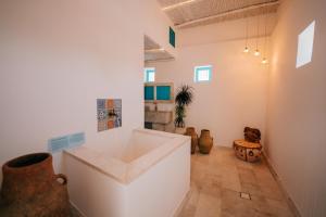 a bathroom with a large tub in a room at Al Bait Al Sharqi in Muscat