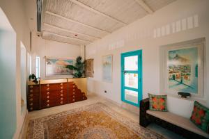 a living room with a bed and a window at Al Bait Al Sharqi in Muscat