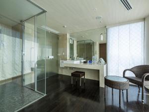 a bathroom with a sink and a glass shower at KOKO HOTEL Premier Hakata in Fukuoka +62 photos