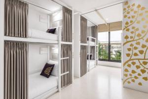 a room with three bunk beds with a hallway at Nappark Hostel @Khao San in Bangkok +44 photos