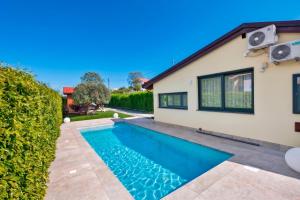 a swimming pool in front of a house at Villa Degli Dei in Agerola
