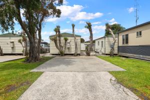 a driveway with palm trees in a yard at Apollo Bay Holiday Park in Apollo Bay