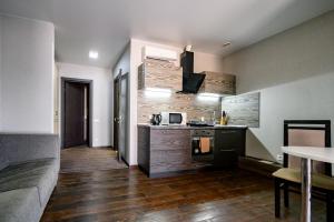 a kitchen with a stove and a sink in a room at G40 Boutique Hotel in Odesa