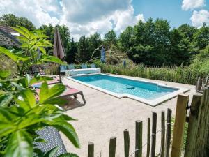 a swimming pool in a yard next to a fence at Domaine de la Jarrige in Saint-Vaury