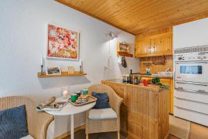 a small kitchen with a table and chairs and a counter at Rustico Stock with free wifi- Happy Rentals in Lugano