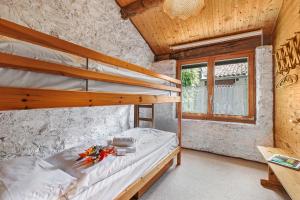 a bedroom with two bunk beds and a window at Rustico Stock with free wifi- Happy Rentals in Lugano