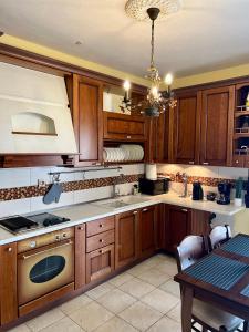 a kitchen with wooden cabinets and a stove top oven at Elia in Ptolemaida