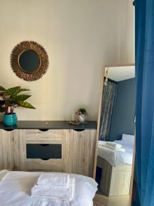 a bedroom with a mirror and a table and a bed at Elia in Ptolemaida