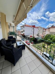 a balcony with couches and a view of a city at Elia in Ptolemaida