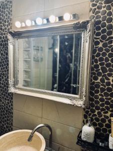 a mirror above a sink in a bathroom at Elia in Ptolemaida +24 photos