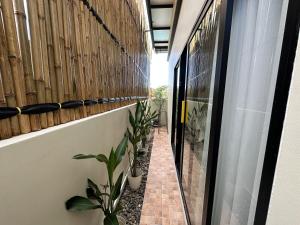 a hallway of a house with plants and a fence at Pomt Lagoon in Ban Khlong Dan