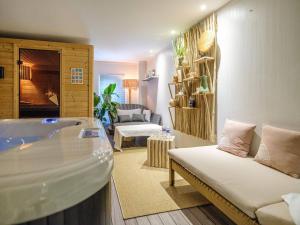 a living room with a tub and a couch at Domaine de la Jarrige in Saint-Vaury +37 photos
