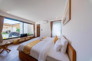 a bedroom with a large bed with a large window at Sekala CoLiving Canggu - Minutes away to Finns and Atlas Beach Clubs in Canggu +105 photos