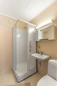 a bathroom with a shower and a sink at Reine Panorama in Reine +12 photos