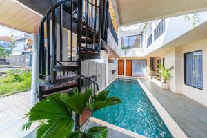 a swimming pool in the middle of a house with a staircase at Sekala CoLiving Canggu - Minutes away to Finns and Atlas Beach Clubs in Canggu
